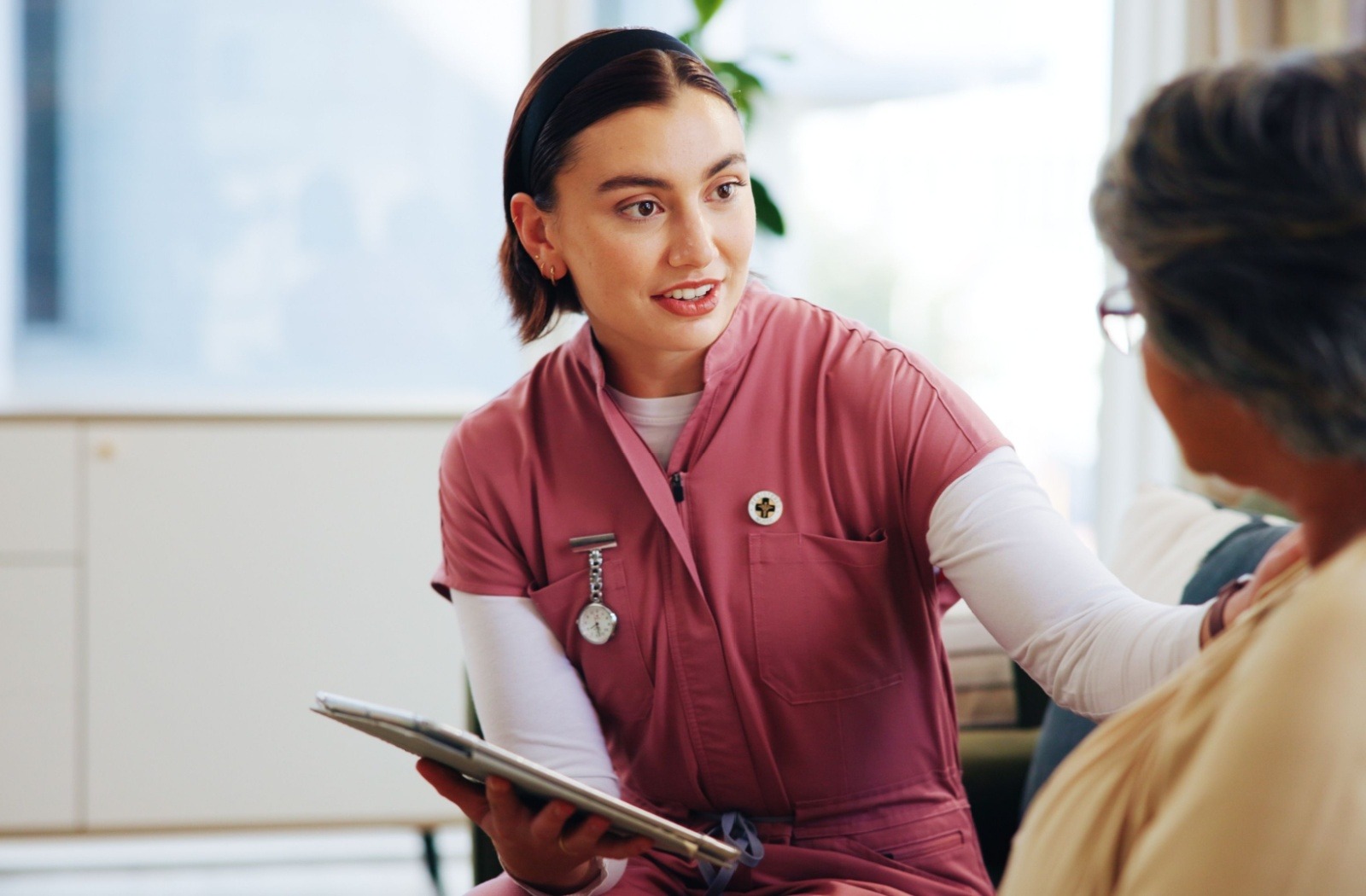 A caregiver speaks to a senior during an assisted living tour
